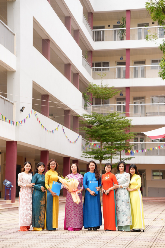 A group of women standing in front of a building

Description automatically generated