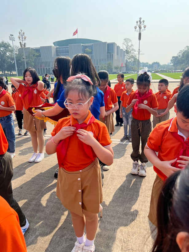 A group of children in orange shirts

Description automatically generated