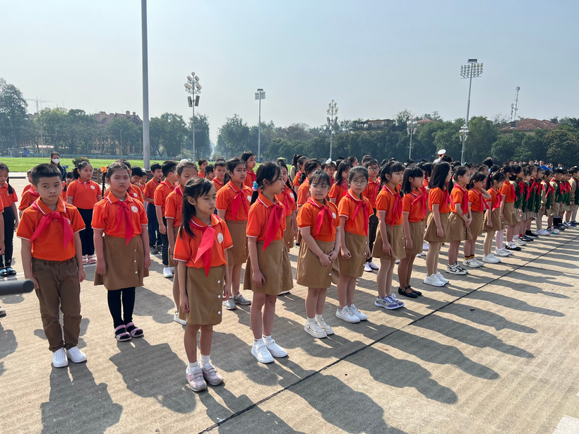 A group of girls in uniform standing in a line

Description automatically generated
