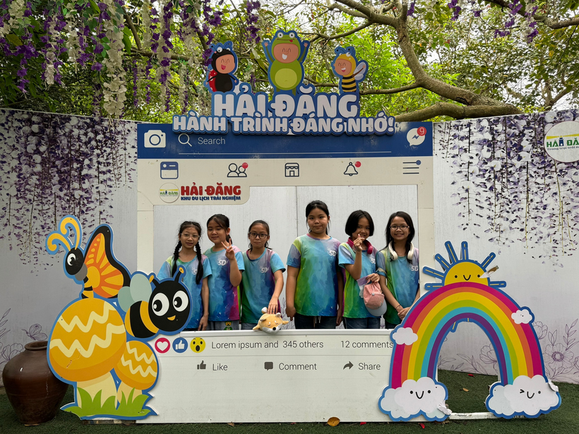 A group of girls standing in front of a sign

Description automatically generated