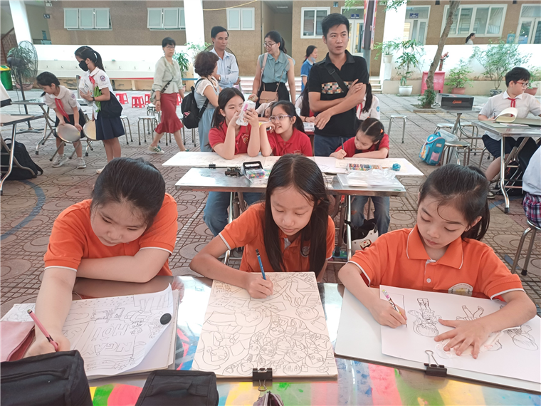 A group of children sitting at desks writing on paper

Description automatically generated